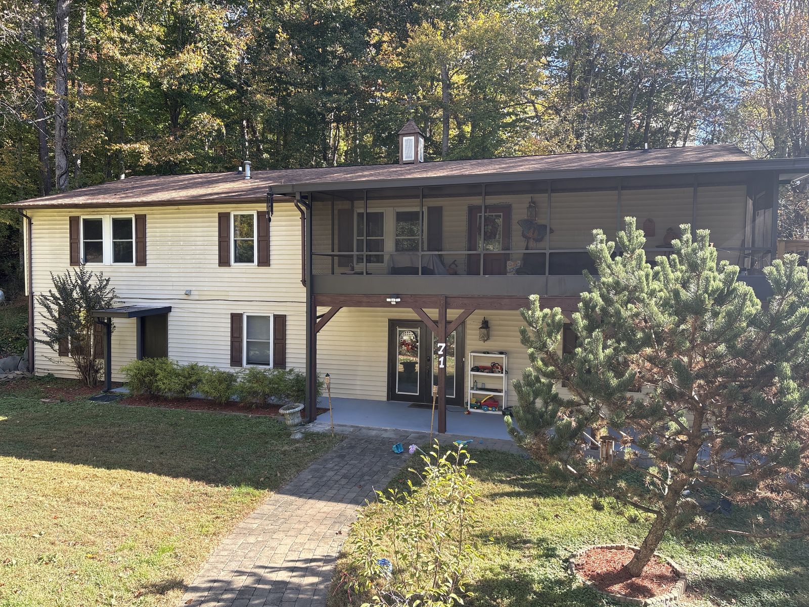 Front of 71 McLean Rd in autumn, with the covered patio below the screened porch and the 71 address post by the door.